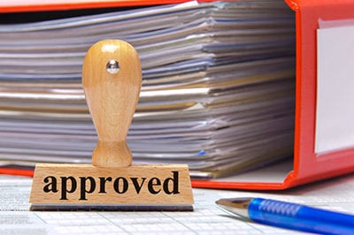 rubber stamp in office marked with approved