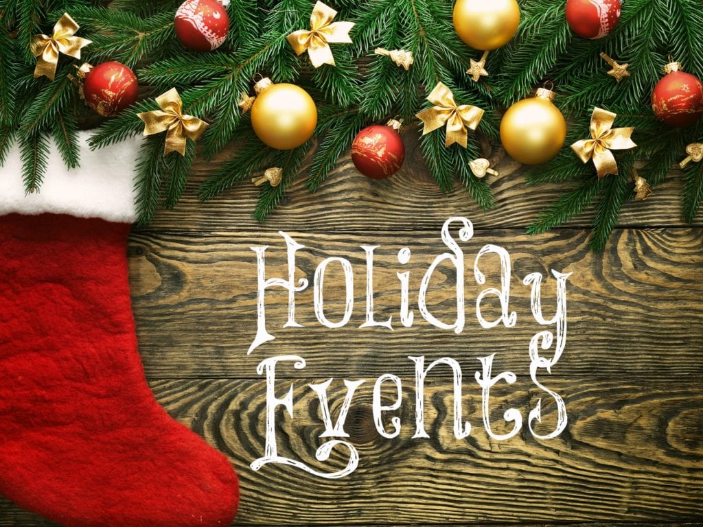 Christmas fir tree and christmas sock with decoration on a wooden board