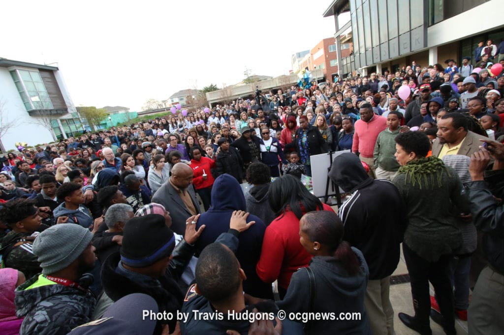 Hundreds of people laid hands on one another and prayed during the candlelight vigil at the Beacon Municipal Courtyard in downtown Decatur. Photos by Travis Hudgons/OCG News